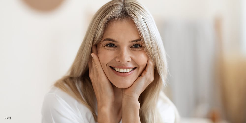 Female touching her face with both hands